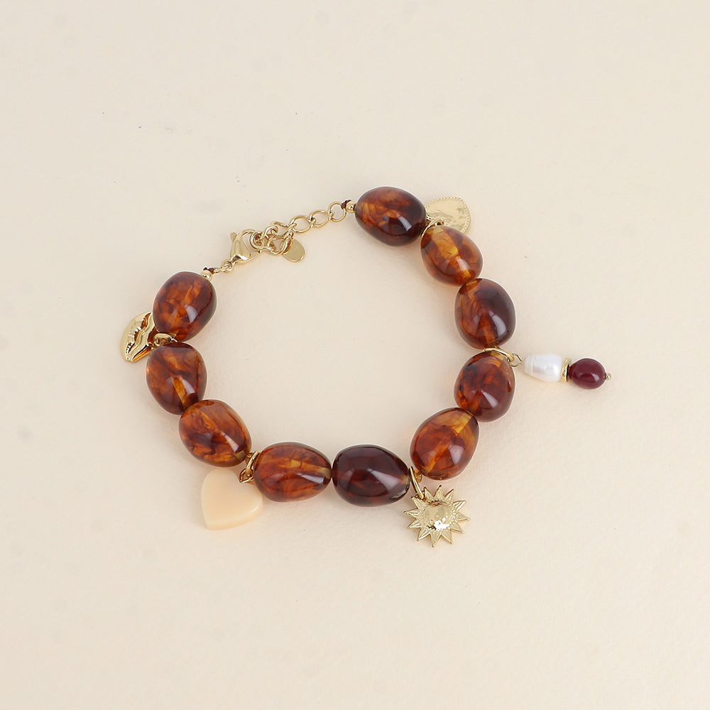 grove bruine kralen armband met grote goudkleurige bedels | stainless steel