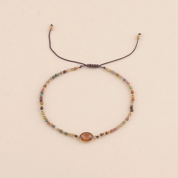 Fijn bruin mineralen armbandje met goudkleurige accenten