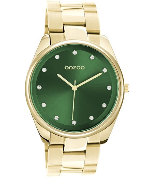goudkleurige ronde oozoo met steentjes op groene wijzerplaat | stainless steel